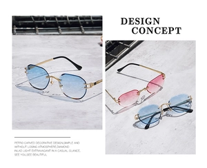 Detail of rimless octagon sunglasses with diamond cut lenses and floral carved gold temples