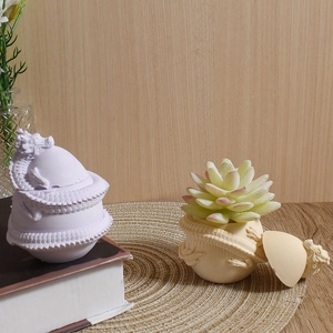 Detailed dragon relief egg-shaped candle cup and succulent planter mold display