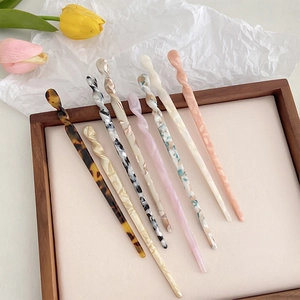 Minimalist twisted acetate hair sticks in various marble patterns for elegant buns