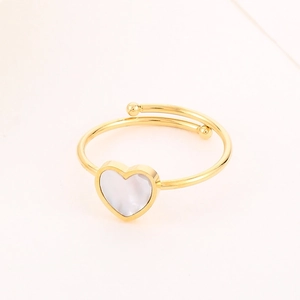 Detailed macro shot of an adjustable gold ring featuring a white heart shell inlay