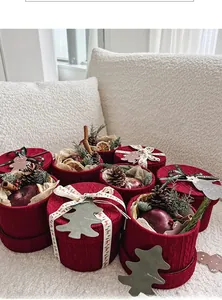 Detail of Christmas gift box with knit texture, pine cones, and festive decor elements