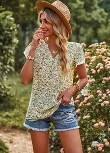 Close-up of green floral V-neck blouse featuring delicate white lace trim on sleeves