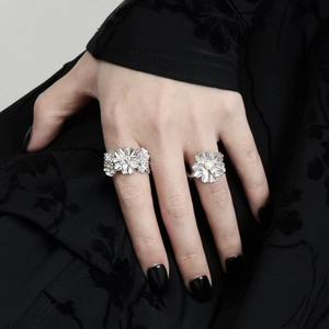 S925 sterling silver flower rings set with pearls shown on a hand against black fabric