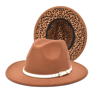 Detail of caramel wool fedora hat featuring leopard print lining and white leather belt strap