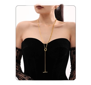 Detailed view of long gold mixed-link sweater necklace with geometric OT buckle toggle clasp