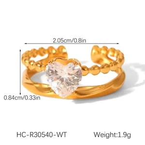 Double-layered gold ring featuring bead and twist textures with a heart zircon accent