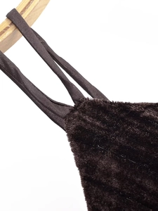 Detail of dark brown plush fabric with subtle glitter and narrow strap attachment