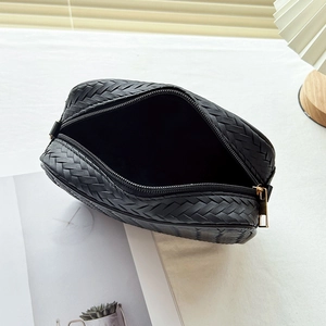 Classic black woven pattern camera bag with gold zipper closure and textured finish