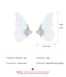 Detail view of blue butterfly wing ear clip with dimensions and 1.6g weight info