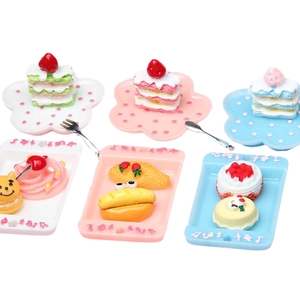 Miniature dollhouse food set with colorful polka dot plates and assorted resin desserts