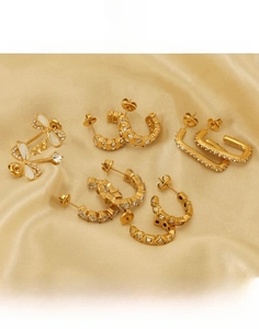 Detailed macro shot of gold-plated titanium steel earrings with crystal butterfly studs