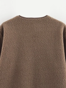 Detail shot of brown fleece jacket showing textured fabric and collar binding quality