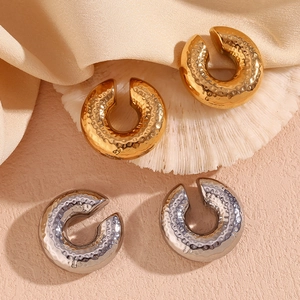 Detailed view of 18K gold and silver plated chunky earrings with hammered texture finish
