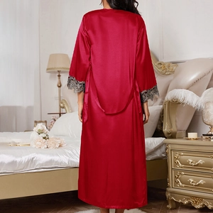 Nuisette longue en satin rouge foncé avec dentelle noire dans une chambre élégante