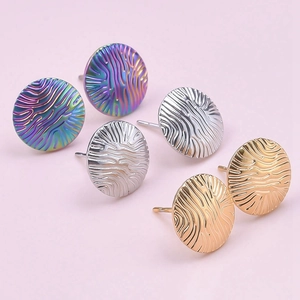 Three pairs of round stainless steel earrings in gold, silver, and rainbow with textured waves