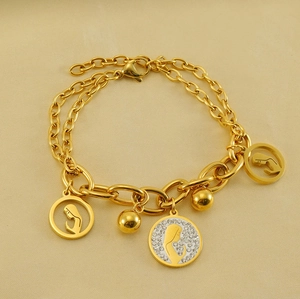 Detail of 18K gold stainless steel layered bracelet with hollow profile pendants on silk