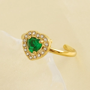 Macro shot of 18K gold plated heart ring featuring green zircon and pavé crystals