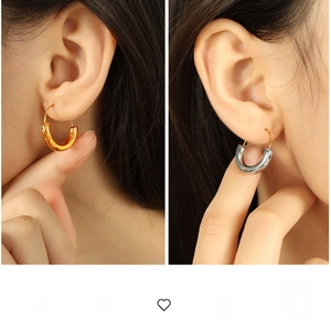 Close-up of minimalist U-shaped geometric earrings in polished gold and silver finishes