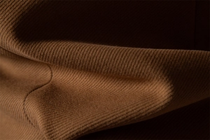 Macro shot of brown knitted fabric texture showing premium wool blend craftsmanship
