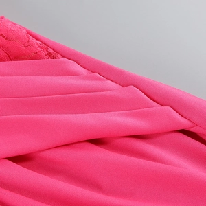Detail of rose red dress featuring intricate lace trim and pleated fabric texture