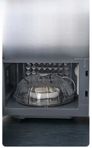 Close-up of clear microwave cover with steam droplets inside showing moisture retention