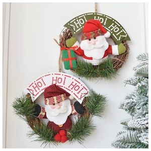 Close-up of Santa Claus plush on pine wreath with HO! HO! HO! holiday text sign