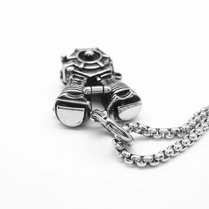 Macro shot of silver motorcycle engine pendant with intricate punk style steel details