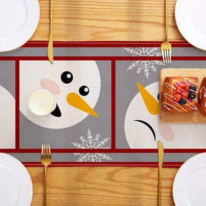 Christmas snowman table runner on wooden desk with gold cutlery and festive decor