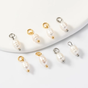 Detail of irregular freshwater pearl pendants with gold and silver loop connectors