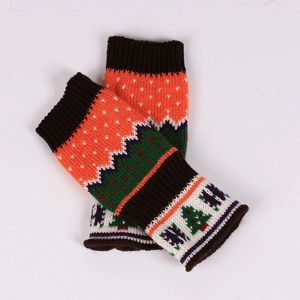 Close-up of festive Christmas tree knit pattern and ribbed cuffs on warm gloves