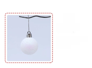 Detail of Christmas ornament ball with white glitter and silver hanging loop design