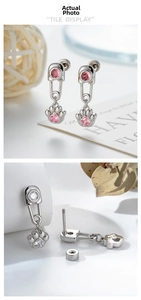 Detail showing paperclip cartilage earring with cat paw heart zircon and screw back closure