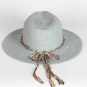 Detail of light blue woven straw hat with tri-color decorative band and tassel knot