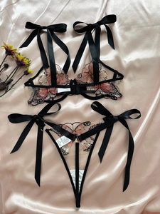 Detailed butterfly embroidery on mesh lingerie set with black satin ribbon ties