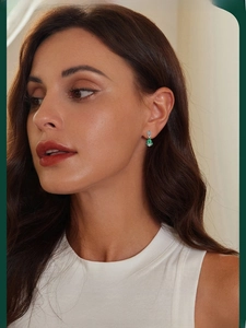 Detailed view of model wearing green enamel Christmas tree earrings in S925 sterling silver