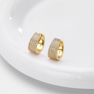 Macro shot of 925 sterling silver stamp on gold hoop earrings with pavé cubic zirconia