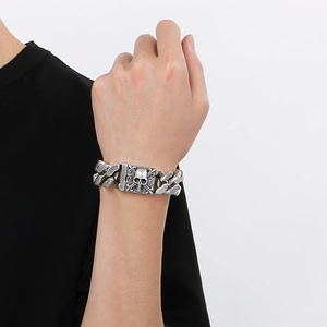 Detailed view of heavy vintage skull clasp on silver stainless steel cuban link bracelet