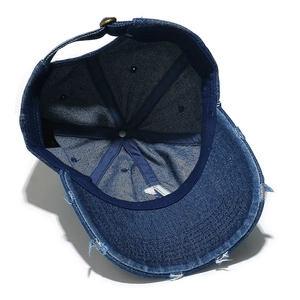 Detailed interior of vintage washed blue denim baseball cap with adjustable metal buckle