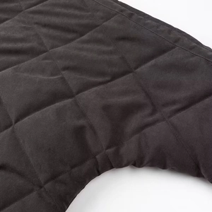 Macro view showing the quilted rhombus texture and fine stitching on the black vintage jacket