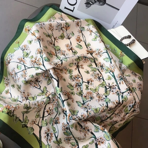 Elegant silk scarf with green butterflies and floral prints on a white bag background
