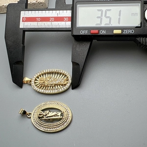 Religious Jesus pendants with cubic zirconia borders measured by digital caliper