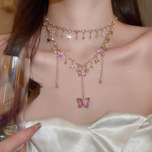 Close-up of elegant double-layered choker with pink crystal butterfly pendants on neck