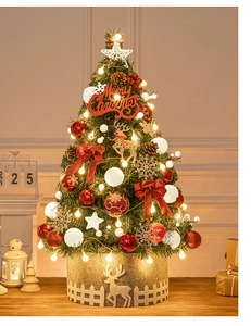 Close-up of 60cm mini Christmas tree with warm LED lights, red bows and pine cones
