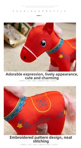 Detailed close-up of intricate traditional embroidery and soft plush fabric on red horse doll