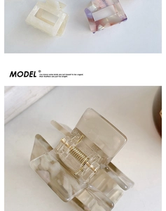 Detail of marble pattern acetate hair claw clip showing durable metal spring and texture