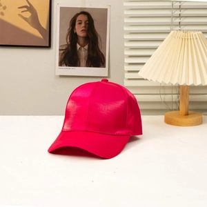 Close-up of a rose pink satin baseball cap featuring a smooth silk-like glossy finish