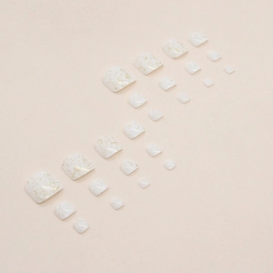 Sparkly white press-on toenails with gold glitter foil design for elegant summer pedicures