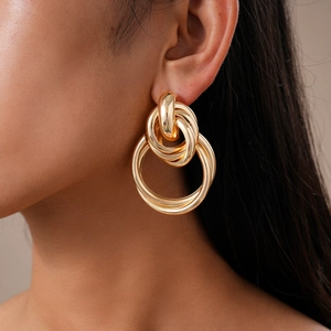Close-up of interlocking gold geometric rings worn by model for a modern look