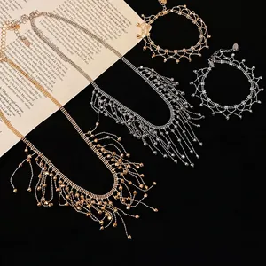 Bohemian style gold and silver tassel necklace and lace bracelet jewelry set on black velvet