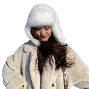 Winter faux fur earflap hat in white paired with cozy plush coat for outdoor warmth